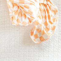 BRIGHT ORANGE + WHITE CHECKER | SWADDLE